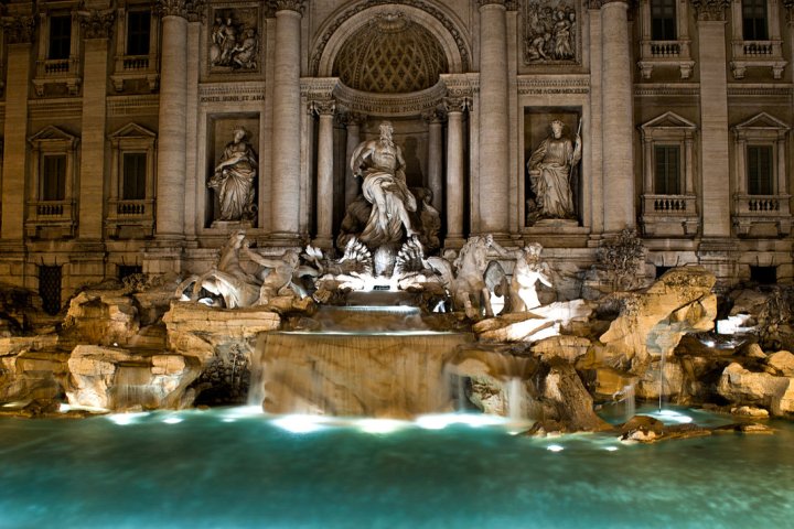 a statue in front of Trevi Fountain