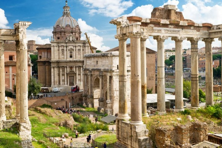 a large stone building with Roman Forum in the background