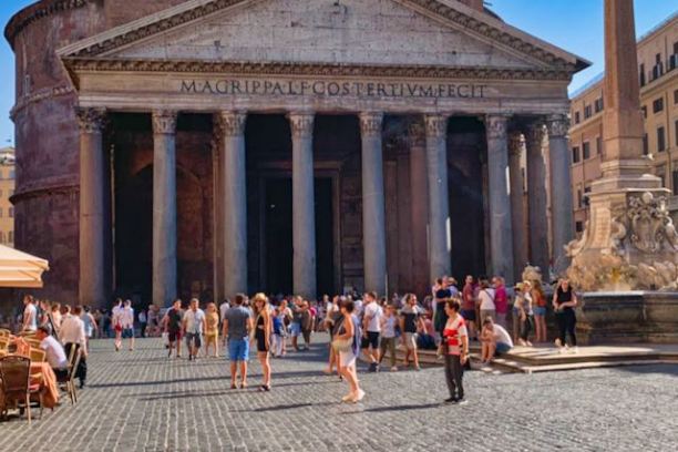 a group of people walking in front of Pantheon, Rome