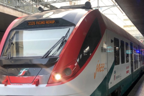 a passenger train pulling into a station