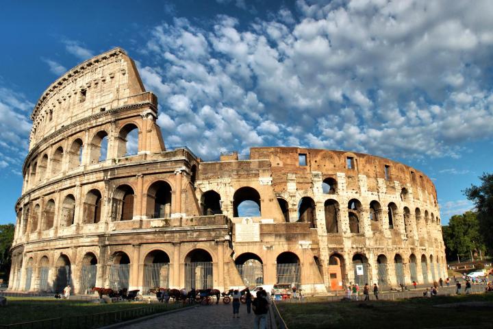 a large white building with Colosseum in the background