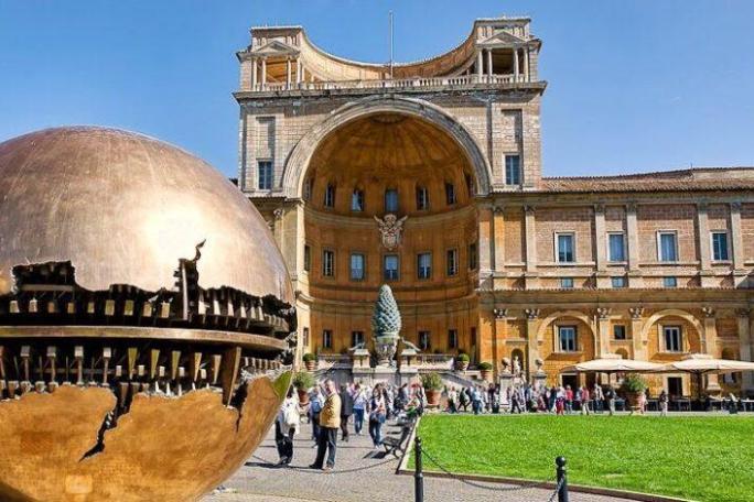 a large building with Vatican Museums in the background
